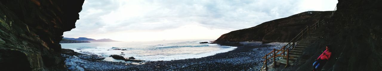 Panoramic view of beach against cloudy sky