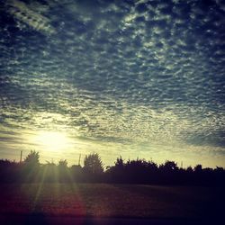 Scenic view of landscape against cloudy sky