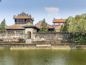 Exterior of building by lake against sky