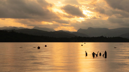 Scenic view of lake against sky during sunset