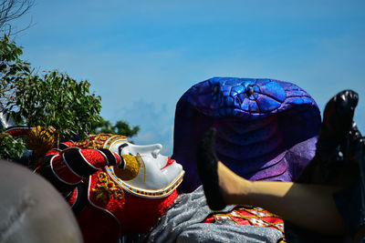 Close-up of sculpture lying on the ground against sky