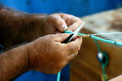 Close-up of man holding fishing net