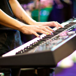 Cropped image of woman playing piano