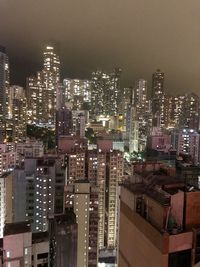 Illuminated buildings in city against sky at night