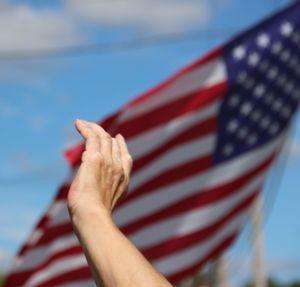 Cropped hand by american flag
