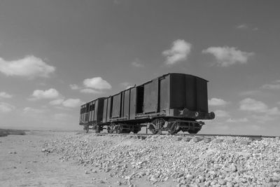 Train on railroad track against sky