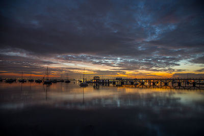 Scenic view of harbor against sky during sunset