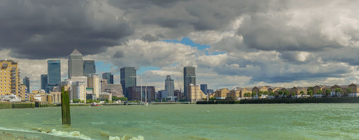 Panoramic view of city against cloudy sky