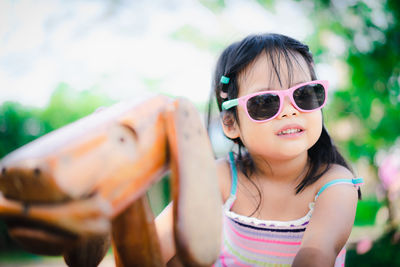 Girl wearing sunglasses playing in ground