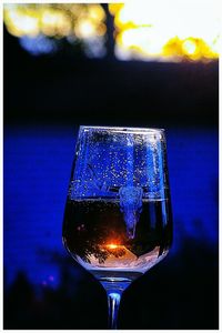 Close-up of wine in glass against black background