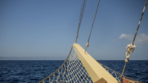 Sailboat sailing on sea against clear sky