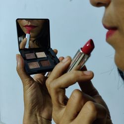 Midsection of woman holding camera