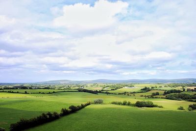 Scenic view of golf course against sky