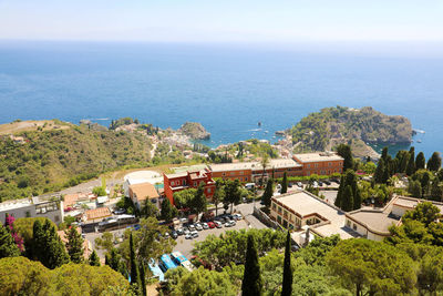 High angle view of buildings by sea against sky