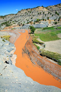 High angle view of river by mountain against sky