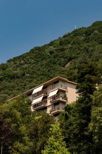 Low angle view of building and mountains against clear sky