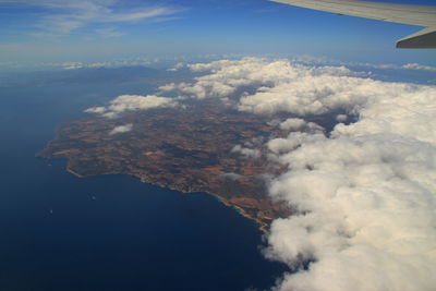 Aerial view of airplane wing against sky