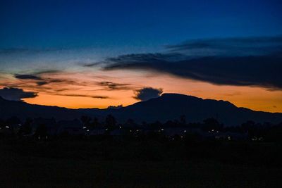 Scenic view of silhouette mountains against sky during sunset