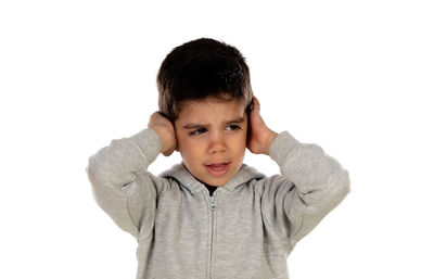 Portrait of boy standing against white background