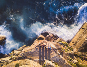 High angle view of woman standing on rock