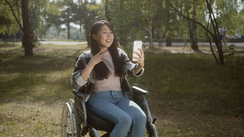 Portrait of young woman using mobile phone