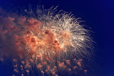 Low angle view of firework display at night