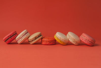 Close-up of cupcakes on table against red background