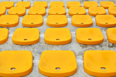Empty yellow bleachers arranged at stadium