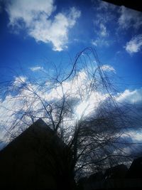 Low angle view of silhouette trees against sky