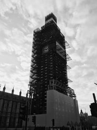 Low angle view of buildings against cloudy sky