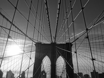 Low angle view of suspension bridge against sky