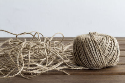 Close-up of string spool on wooden table