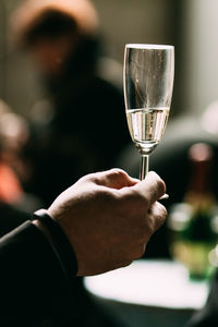 Close-up of man holding glass of wine