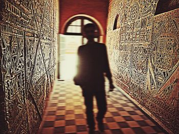 Shadow of woman on cross at temple