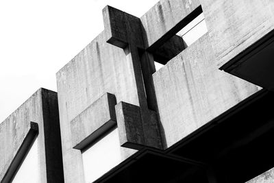 Low angle view of cross on building against clear sky