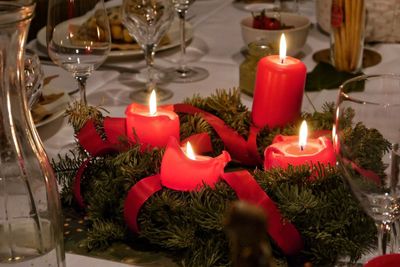 Close-up of lit candles on table