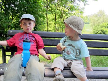 Front  view of friends sitting outdoors