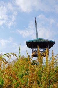 Low angle view of sculpture on field against sky