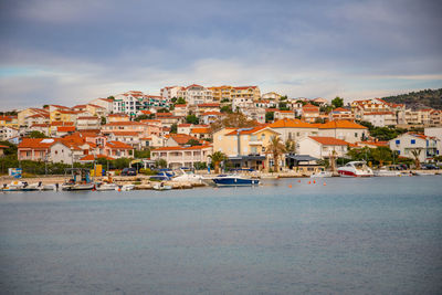 Townscape by sea against sky