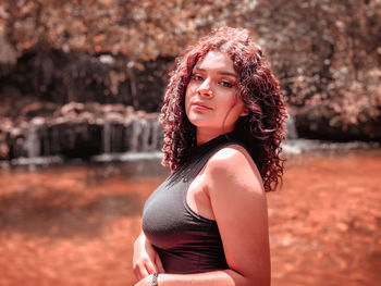 Portrait of beautiful young woman standing outdoors