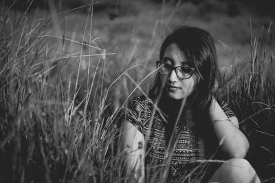 Portrait of smiling young woman standing on field