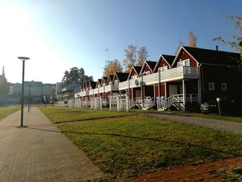 Houses by street against sky in city