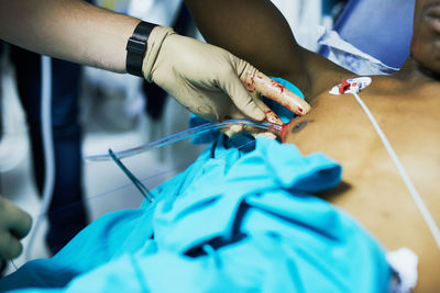 Midsection of doctor examining patient