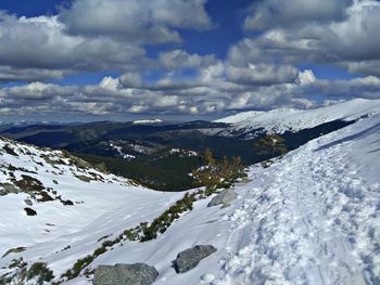 Scenic view of snowcapped mountains against sky