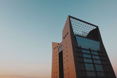 Low angle view of modern building against clear blue sky