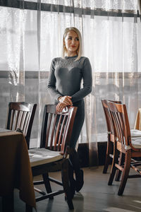 Portrait of a smiling young woman sitting on table