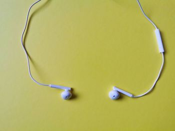 High angle view of yellow keys over green background