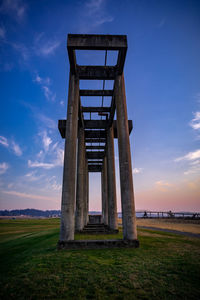 Built structure on field against sky during sunset