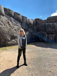 Full length portrait of man standing on rock