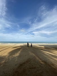 People on beach against sky